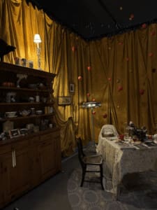 Instilation at the Shed, hanging apples, and warm lighting.